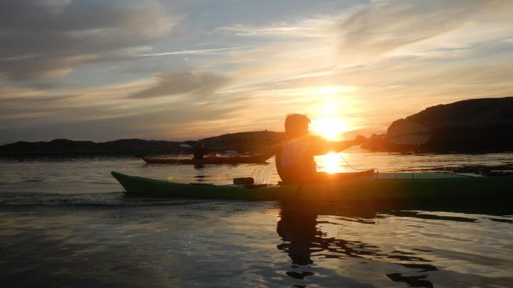 Two people kayaking in a beautiful sunset. 