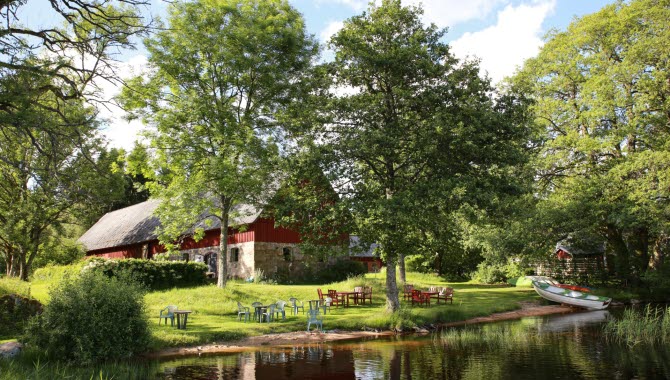 Red barn next to a lake.
