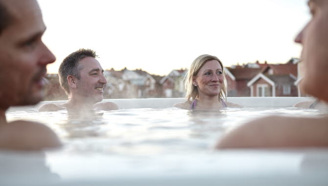 Group of people sharing a bath in a hot tub at Smögen in winter time